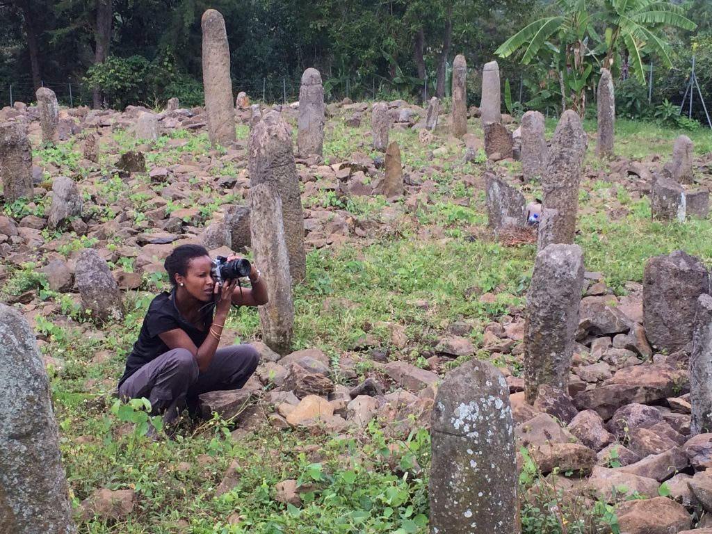 Dr Sada Mire investigating sacred landscapes in Ethiopia and photographing the Tuto Fela, World Heritage Site