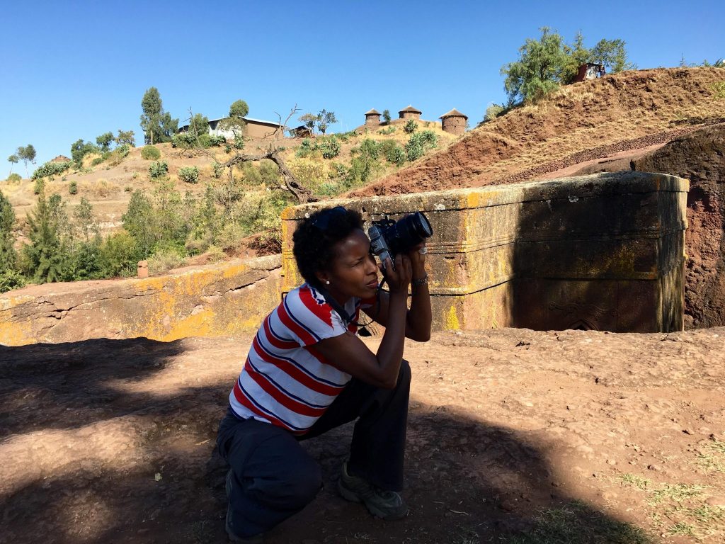 Dr Sada Mire at the rock hewn churches of Lalibela, World Heritage Site, sacred landscape in Ethiopia, 2015